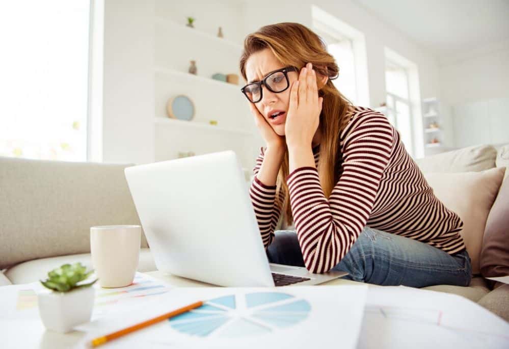 Woman on laptop making freelancing mistakes