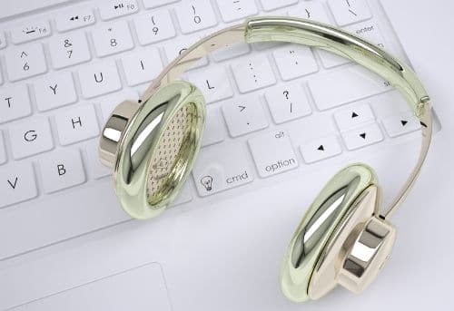 Image of silver headset and white keyboard for audio transcription jobs from home