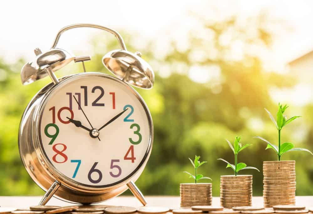 Clock and money growing showing how to save money for the future