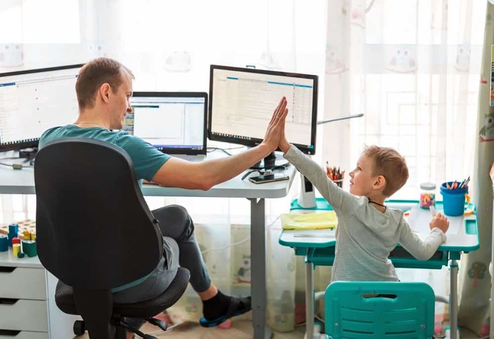 father and son working at home at desk